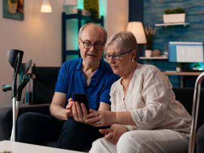 Old man and woman looking at smartphone screen